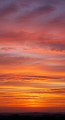 Stunning vibrant sunset sky with orange and pink clouds at dusk