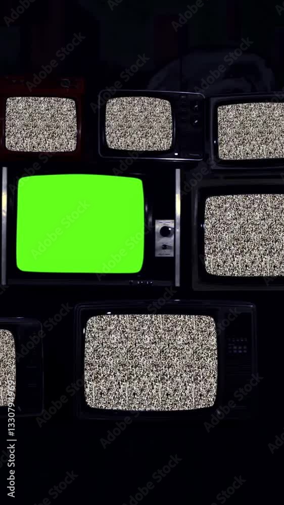 Wall mural remote turns on stack of tvs with static noise and central green screen - zoom-in - vertical 4k