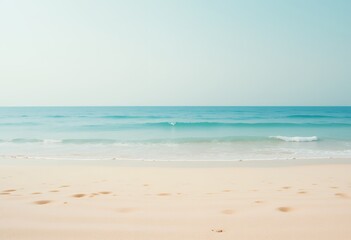 Obraz premium Serene Ocean View with Footprints on Sand, a Calm and Peaceful Scene