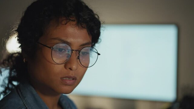 A close-up of a concentrated female coder, bringing to life the intersection of technology and artistry in the workplace.