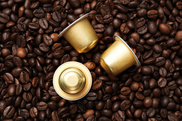 Many coffee capsules on beans, top view