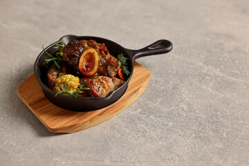 Delicious grilled meat and vegetables served on light grey table. Space for text