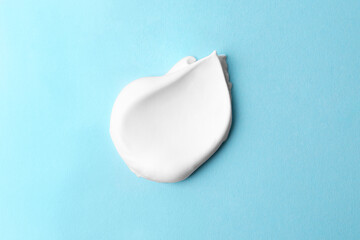 Sample of fluffy foam on light blue background, top view