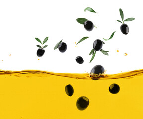 Black olives and green leaves falling into cooking oil on white background