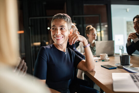 Confident businesswoman smiling during a meeting in modern office