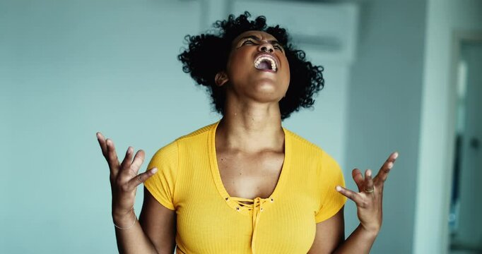 One frustrated young black woman screaming in despair at sky gesturing with hands body feeling distraught and overhwelmed by problems, 20s person wanting to give up