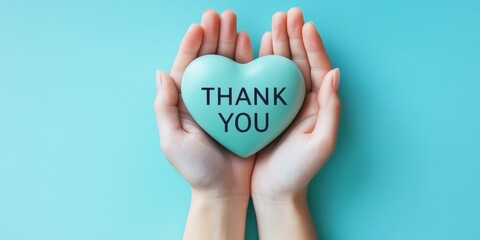 Heartfelt gratitude gesture hands holding thank you stone vibrant blue background emotional appreciation close-up perspective
