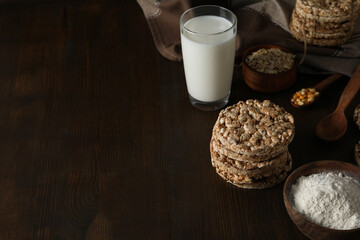 Crisps bread with milk and ingredients, on a dark background.