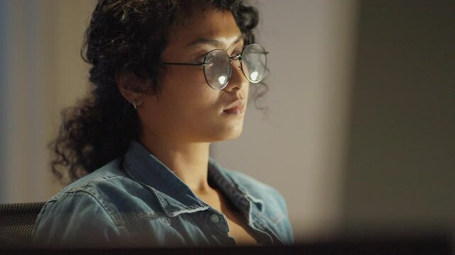 Asian entrepreneur as she navigates her coder&rsquo;s journey, beautifully captured in a late-night, light-illuminated setting.