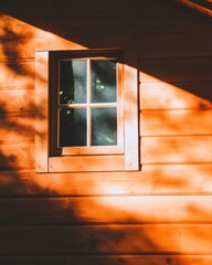 Golden Hour Architectural Minimalism Warm Wooden Cabin Window with Moody Shadow Play - Contemporary Rural Design and Atmospheric Lighting Aesthetic