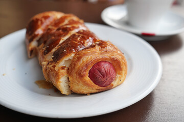 Delicious pastry with sausage served at a cozy cafe