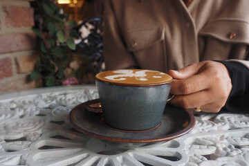 Coffee served in a stylish cup during a cozy cafe visit