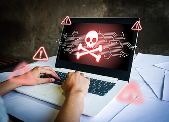 Cybercrime concept with hacker hands on laptop showing red skull and warning signs on screen. Symbolizing hacking, data breach, malware, cyber attack, online fraud, and digital threats.