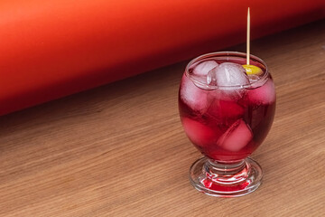 Refreshing berry bliss cocktail. This vibrant cocktail features a delicious blend of berry flavors, served over ice in an elegant glass. Selective focus.