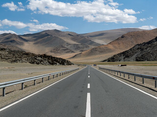 Endless road in Mongolia, big highway going through the remote and wild landscapes of Mongolia