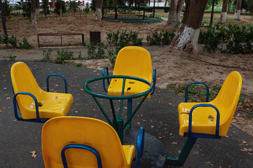 Children's carousel with yellow seats