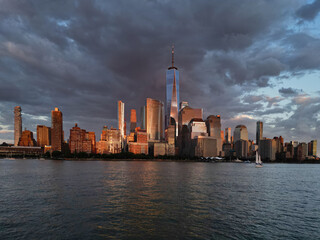 Obraz premium New York City top view. NYC aerial view, New York City Skyline with dramatic sky. Panoramic drone view on Manhattan in NY. Sunset in NYC. New York City Midtown skyline view at dusk with clouds.