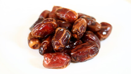 Dried dates on a white background.