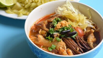rice vermicelli with northern thai curry sauce on blue background