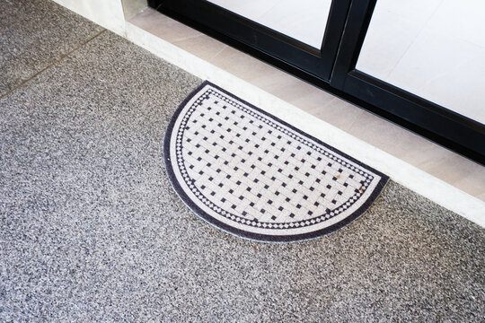 Black carpat in coffee shop,modern door mat entryway outdoor mat Welcome mats entry grey mat on floor,selective focus..