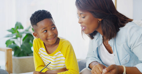 House, woman and child with homework, writing and studying with son in living room, smile and care...
