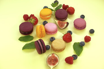 Table filled with array of macaroons and fruits