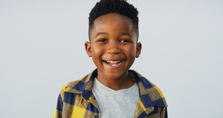 Portrait, black child and boy laughing in studio with funny adorable model isolated on white...