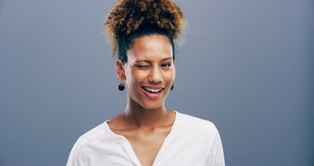 Wink, african and portrait of woman in studio for secret, agreement and support gesture. Happiness,...