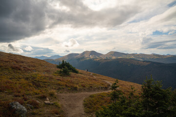 Lone hiker standing on alpine tundra in Rocky Mountain National Park