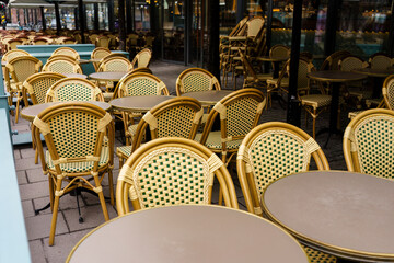 Empty wicker chairs and tables at outdoor European cafe