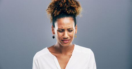 Obraz premium Studio, crying and woman with depression, sad and emotional for loss of relationship, divorce and grief. Mockup space, blue background and person with heartbreak for breakup, disappointed and pain