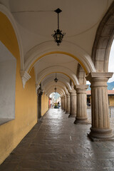 Fototapeta premium Silhouette of woman looking through window in historic site, La Antigua, Guatemala