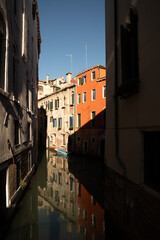 Sunlit Canal with Historic Buildings in Venice, Italy
