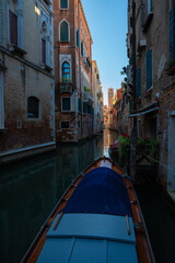 Sunlit Canal with Historic Buildings in Venice, Italy
