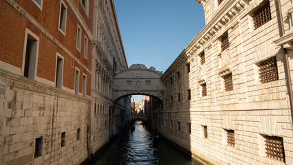 Sunlit Canal with Historic Buildings in Venice, Italy
