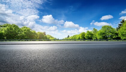 asphalt road and green trees in the blue sky