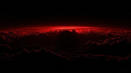 Red Glowing Horizon Over Dark Cloudscape at Night