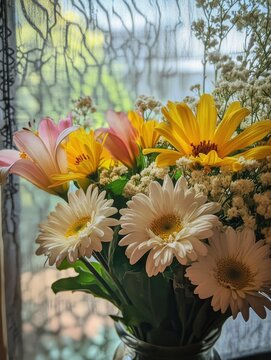 Beautiful Arrangement of Pink and Yellow Flowers in a Vase Near a Window with Soft Natural Light Filtering Through Sheer Curtains