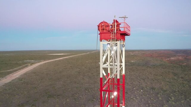 Drilling rig on Vaca Muerta drilling set at dusk. Pink and blue sky