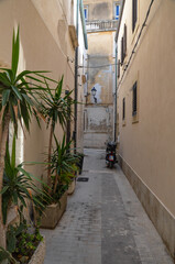 scooter on a charming narrow street in Syracuse, Sicily
