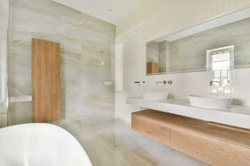 This contemporary bathroom features sleek designs, elegant fixtures, and a calming color palette, creating a serene and inviting atmosphere.