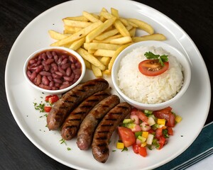 Grilled Sausage Platter with Fries, Rice, Beans, and Fresh Salad - A Hearty Meal