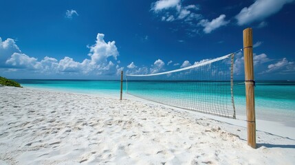 Beach volleyball net on pristine white sand, turquoise ocean backdrop. Perfect for travel, summer, or recreation websites and social media.