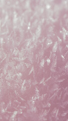 Capturing delicate ice crystals glistening in soft pink hues, creating a stunning winter wonderland backdrop filled with intricate patterns and serene beauty