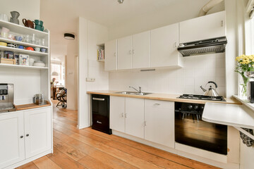 A bright and modern kitchen featuring sleek cabinetry, a cozy layout, and inviting decor elements...