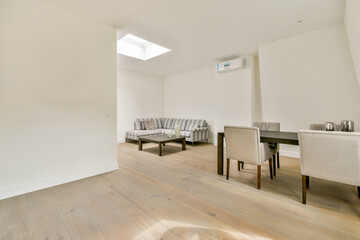 Bright and airy modern interior showcasing a simplistic design with a cozy seating arrangement and stylish decor elements that create a welcoming atmosphere.