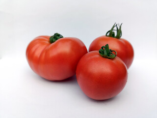 Three Fresh Red Tomatoes on White Background