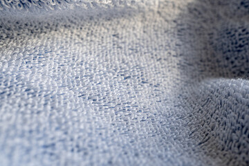Soft white color cotton towel backdrop, fabric background. Terry cloth bath or beach towels. Macro.