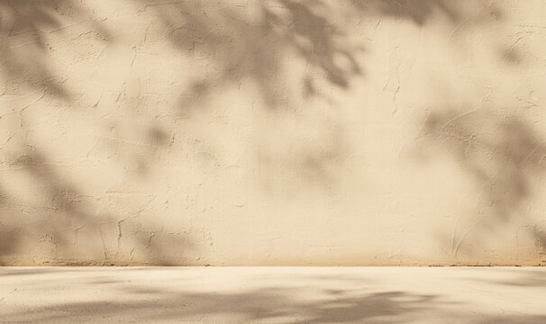 Empty beige background with sunlight superimposed shadow leaves on the wall. autumn background template for product presentation concept.