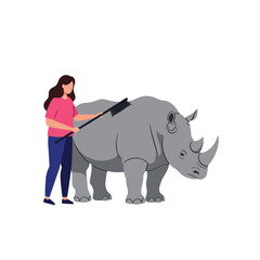 Obraz premium Woman grooming a rhinoceros in a flat vector illustration design style